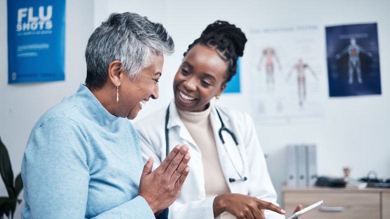 smiling doctor talking with patient