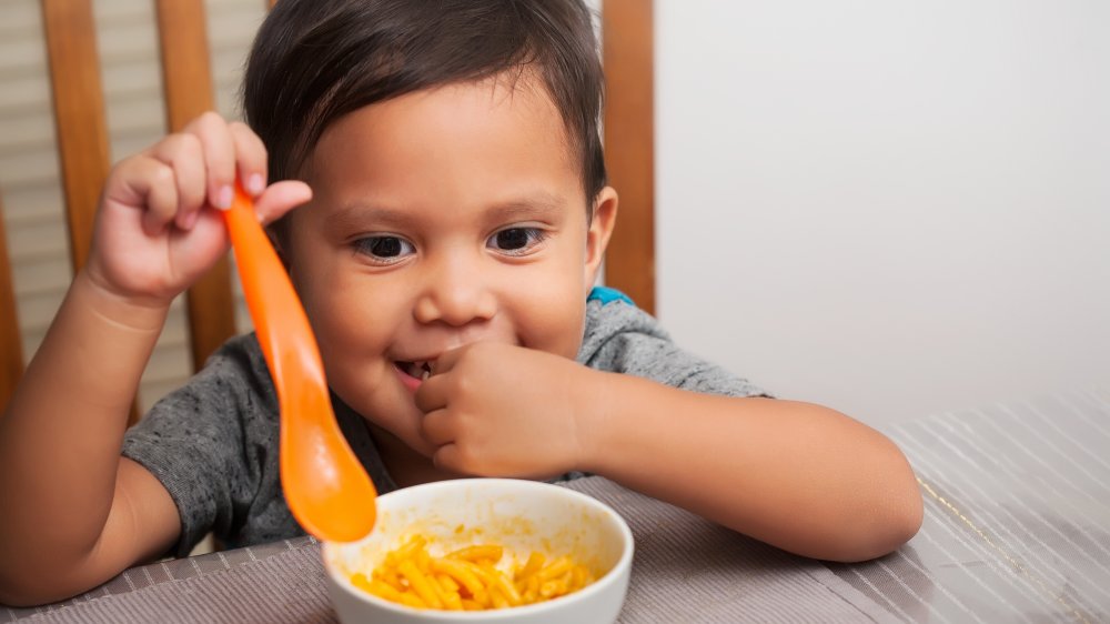 Kid eating mac and cheese