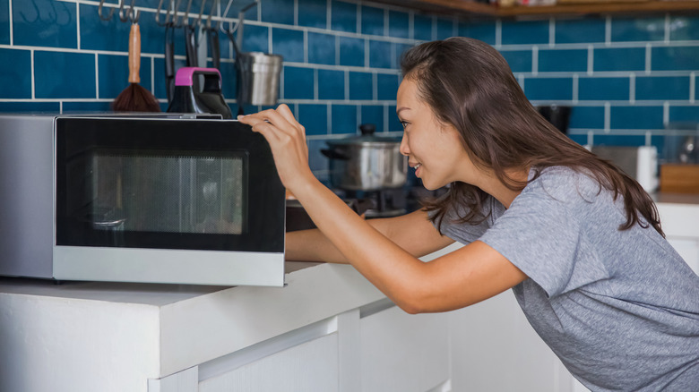 Woman using microwave