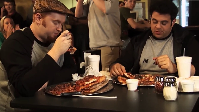 Pair attempting pizza challenge