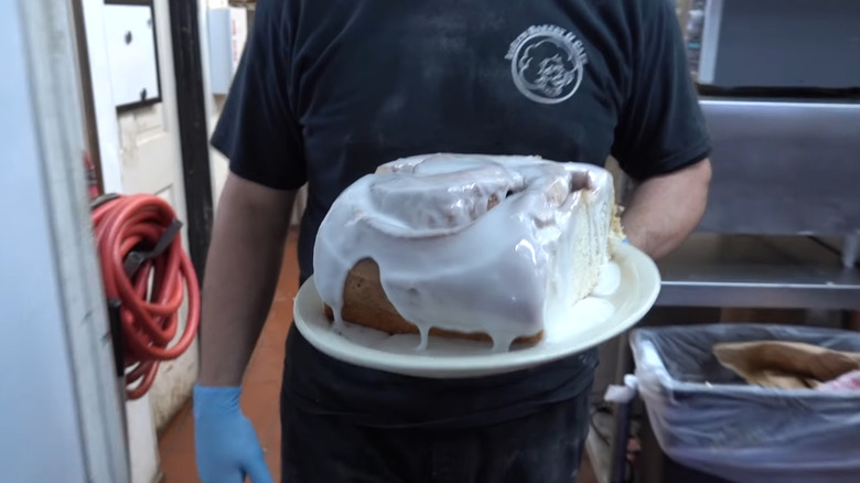 Huge cinnamon roll being carried