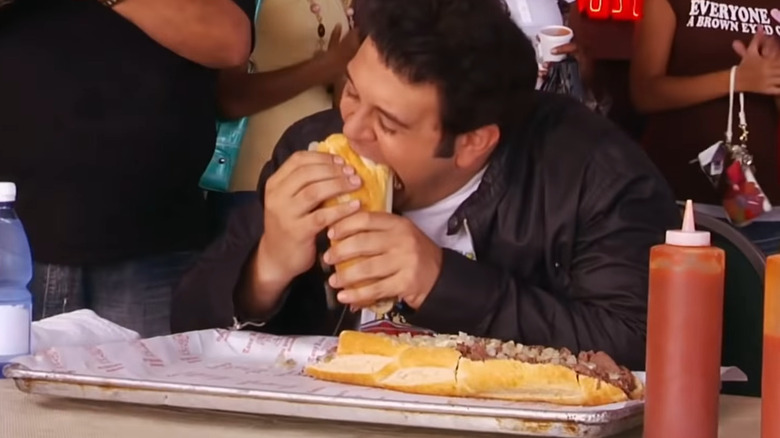 Adam biting giant cheesesteak