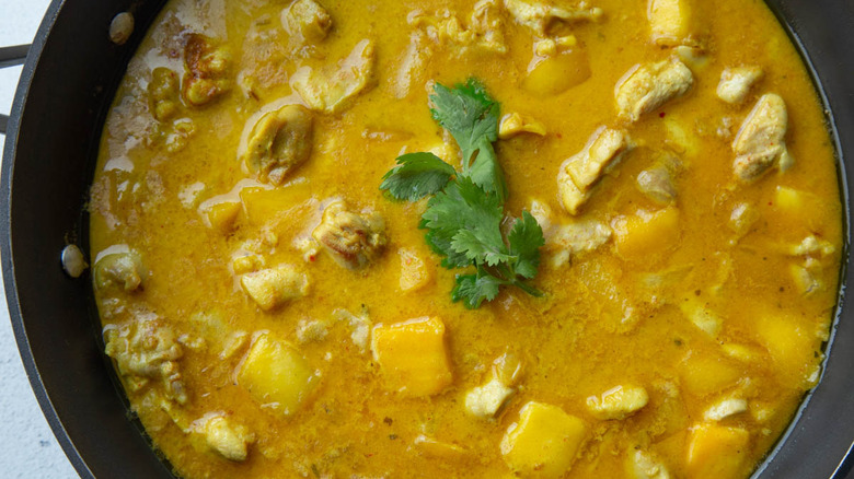 mango chicken curry in skillet