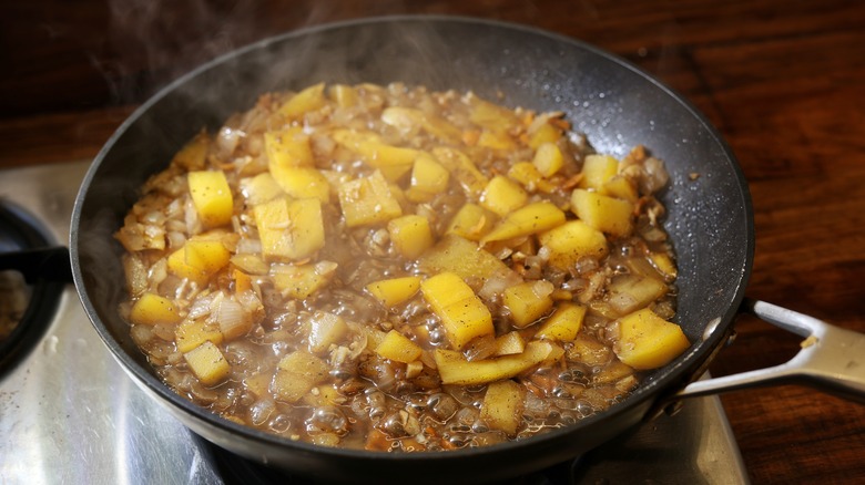 skillet of simmering mango sauce