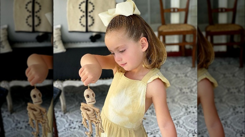 Marcela Valladolid's daughter holding skeleton toy