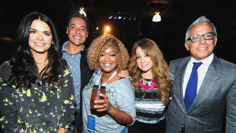 The original cast of "The Kitchen" posing together and smiling 