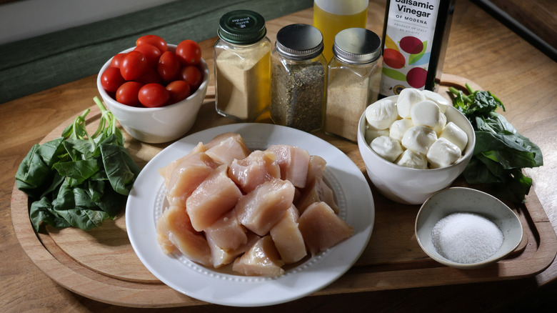 Margherita chicken skewers ingredients on cutting board on wooden table