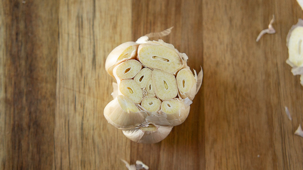 bulb of garlic with the top cut off for marinara sauce