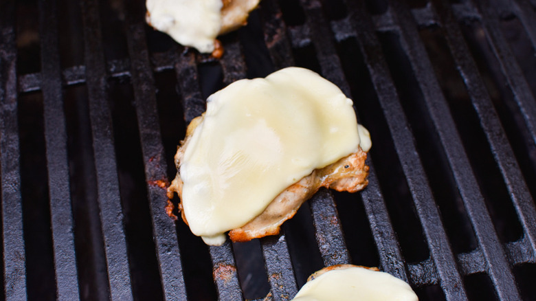 cheese on grilled chicken thighs