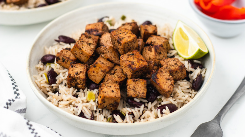 Jerk tofu in bowl with rice and peas