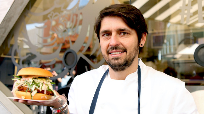 Chef Ludo Lefebvre holding a burger