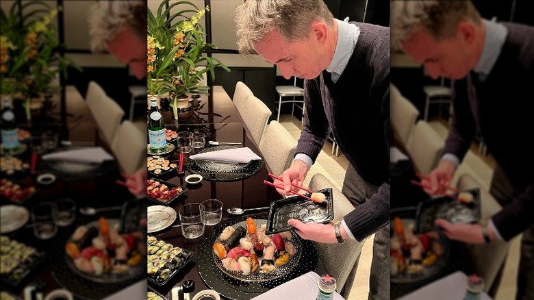 Kevin Sharkey serving sushi at his dinner table