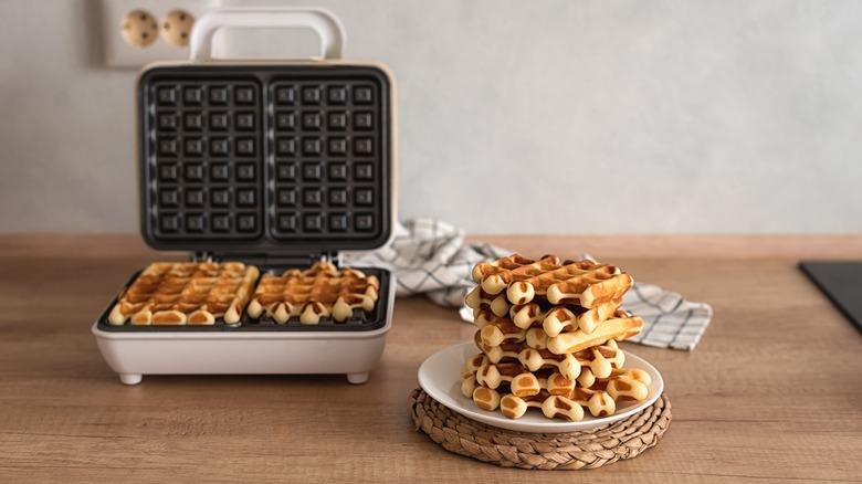 waffle iron and cooked waffles