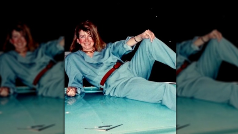 Young Martha Stewart laying on car