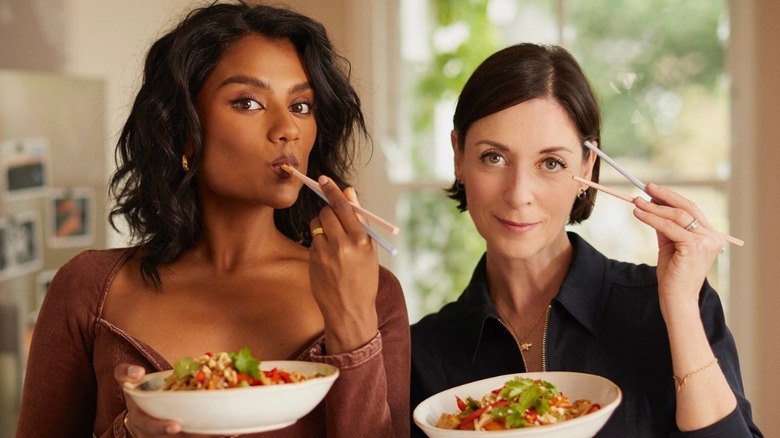 Simone Ashley and Mary McCartney eating noodles