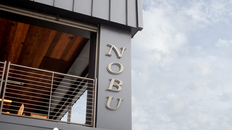 Nobu sign on open-air restaurant next to sky