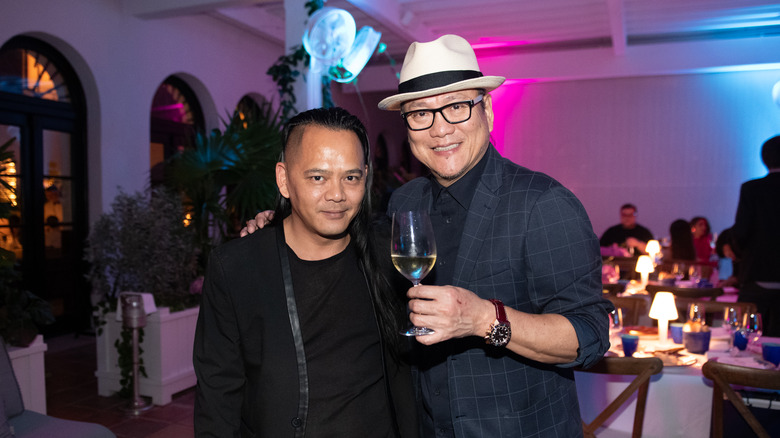 Chef Morimoto holding wine glass