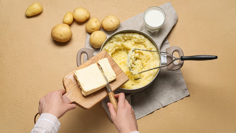 Adding butter to mashed potatoes