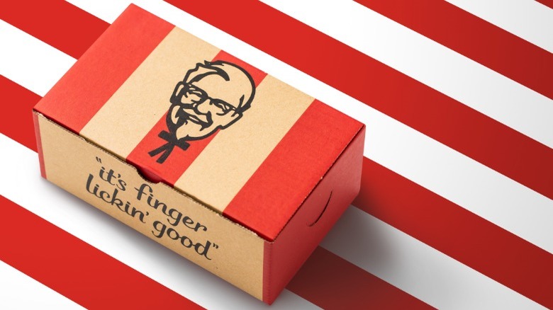 KFC takeout container displaying "It's finger lickin' good" logo on red and white striped background