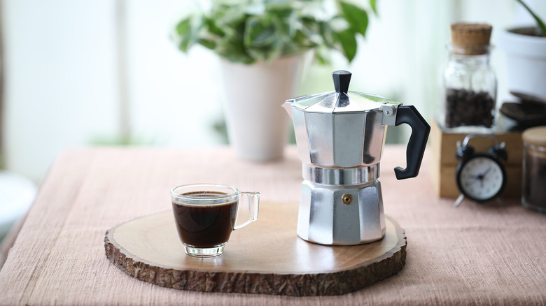 moka pot with cup of cofee