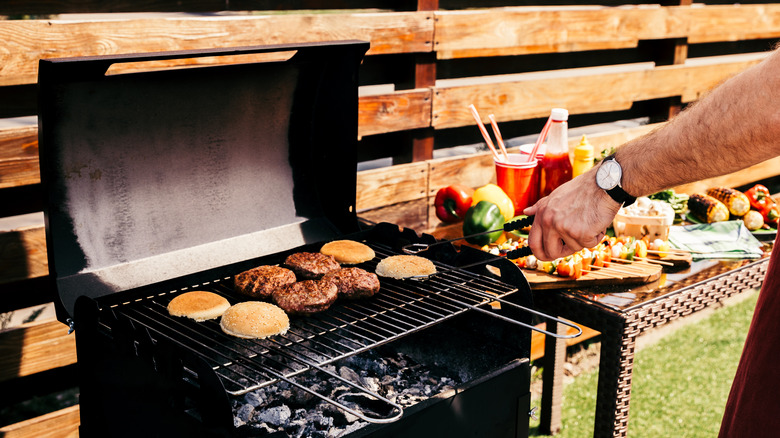 Person grilling burgers