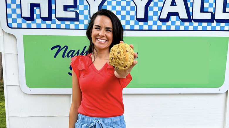 Chef Whitney Miller holding one of her cookies.