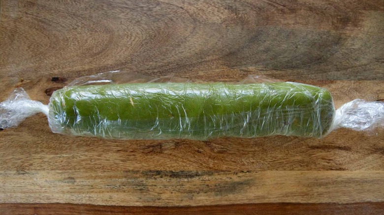 plastic-wrapped green dough log