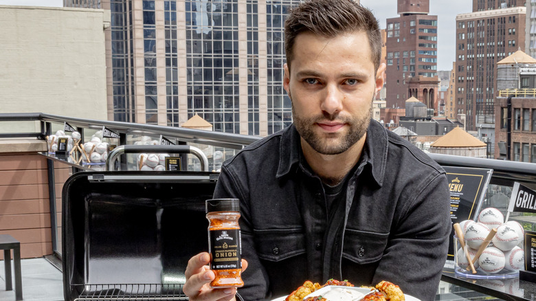 Max Greb holding McCormick seasoning and plate of wings