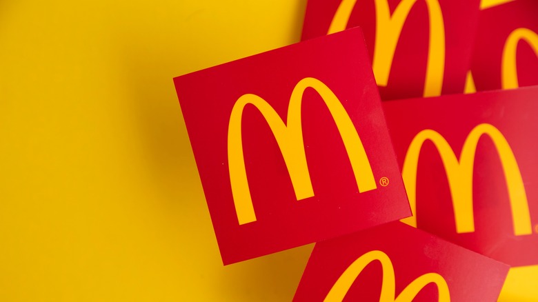 McDonald's trademark Golden Arches on red squares against a yellow background