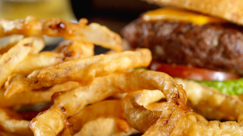 Onion rings next to burger