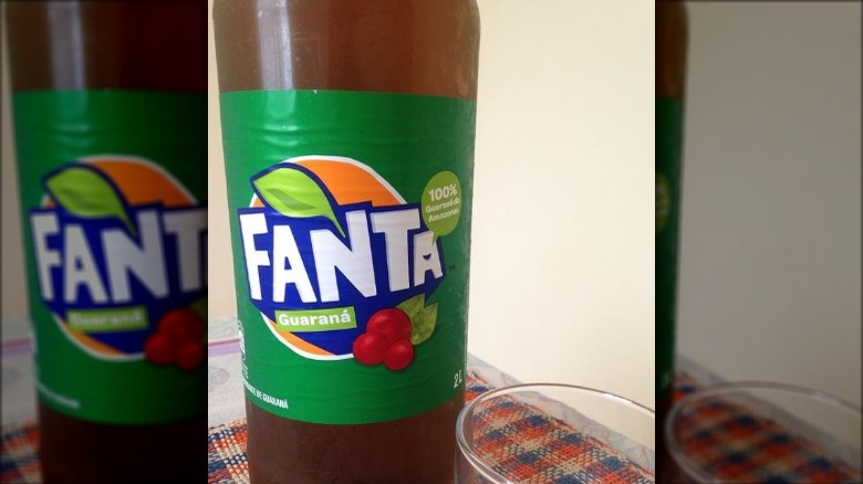 Bottle of Fanta Guarana and glass