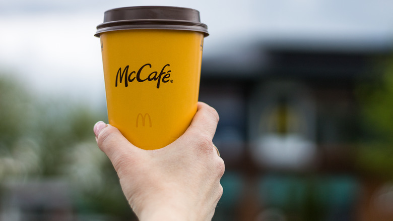 hand holding McDonald's coffee cup