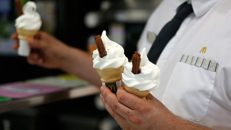 manager holding ice cream cones