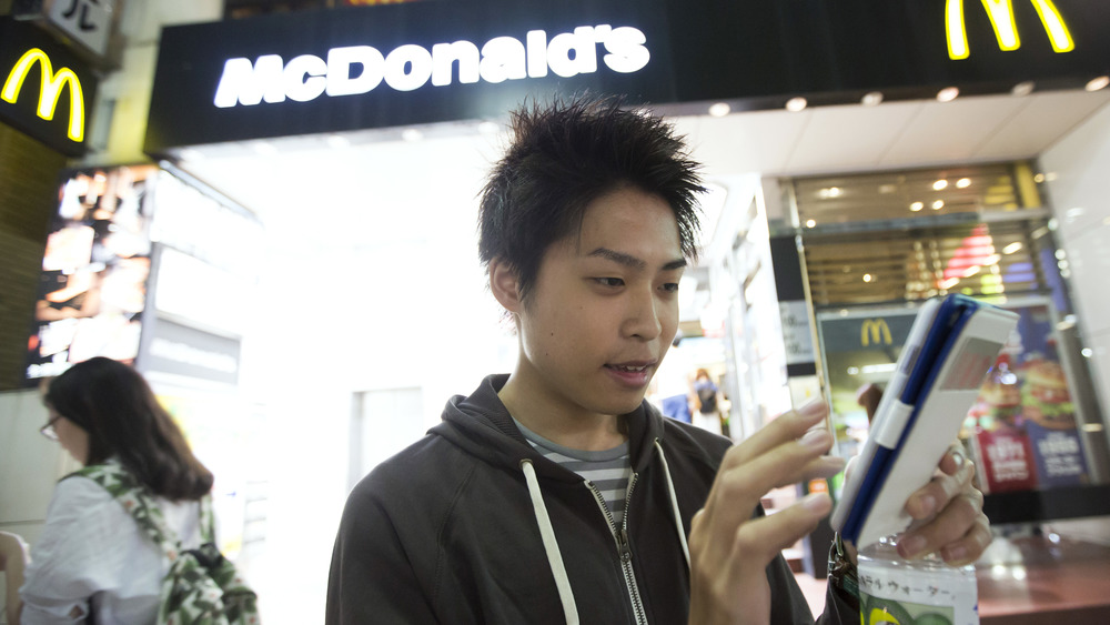 Man using smartphone at McDonald's