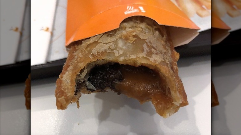 Salted caramel and chocolate pie with bite taken out