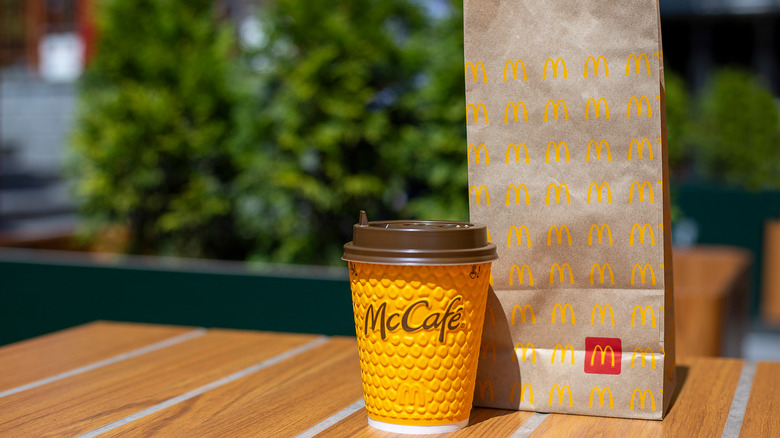 McDonald's coffee and bag on a table