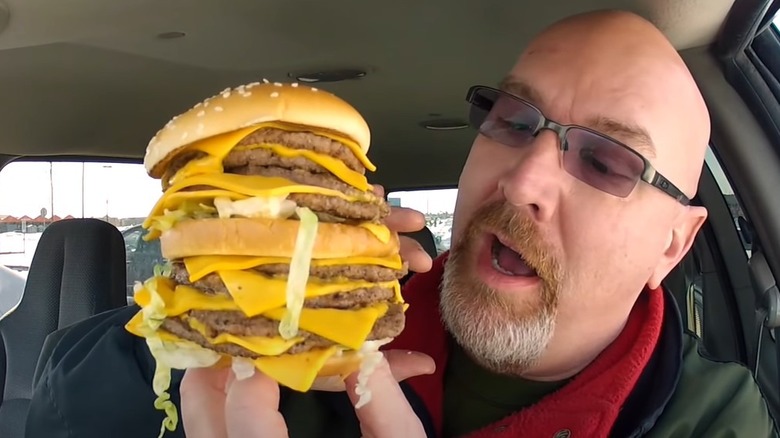 Man holding Monster Mac sandwich