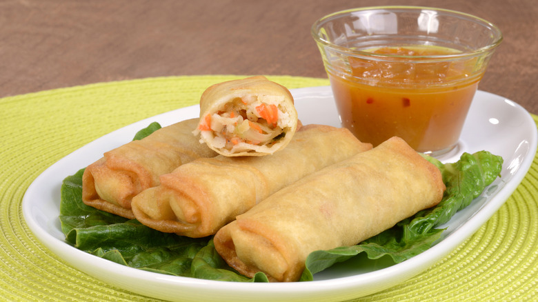 plate of egg rolls with plum sauce