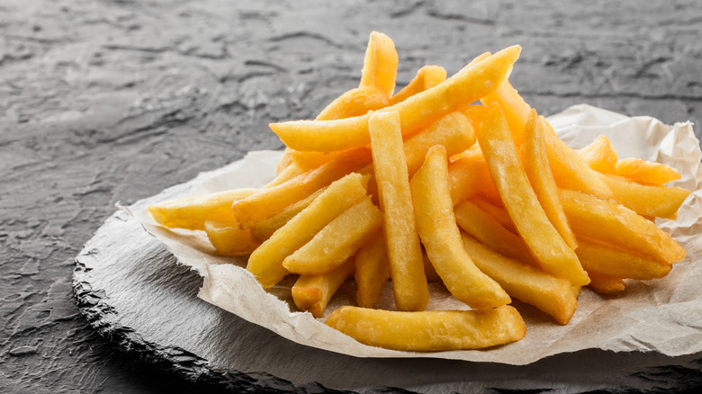 french fries on fancy serving plate made of slate