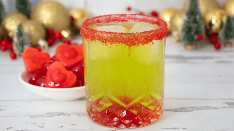 Grinch cocktail next to bowl of heart-shaped ice