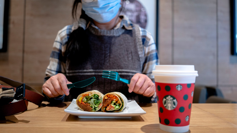 Starbucks Beyond Meat wrap next to coffee cup