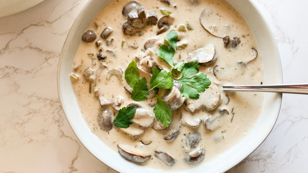 Mushroom soup in bowl with parsley 