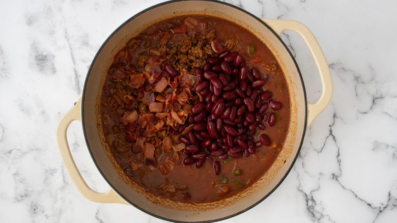 bean meat chili ingredients to pot