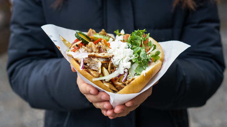 A chicken pita with vegetables and feta cheese