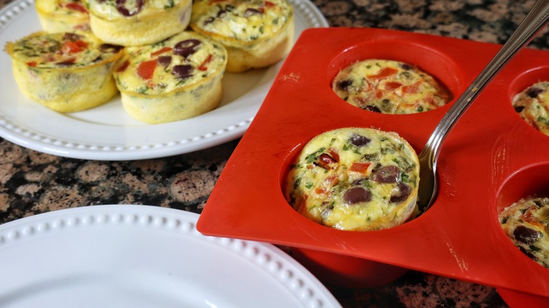 scooping egg bite from muffin tin