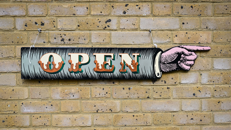 open sign on brick wall