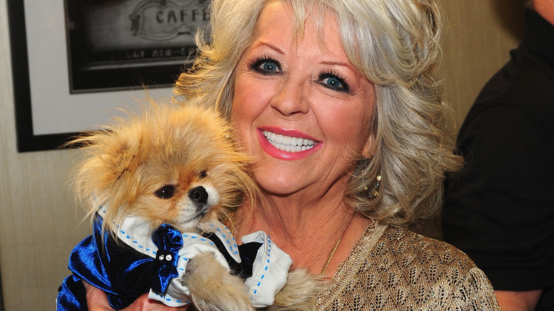 Paula Deen holding a dog