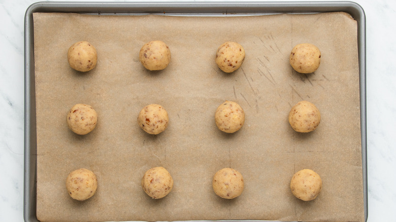 cookie dough balls on baking sheet 