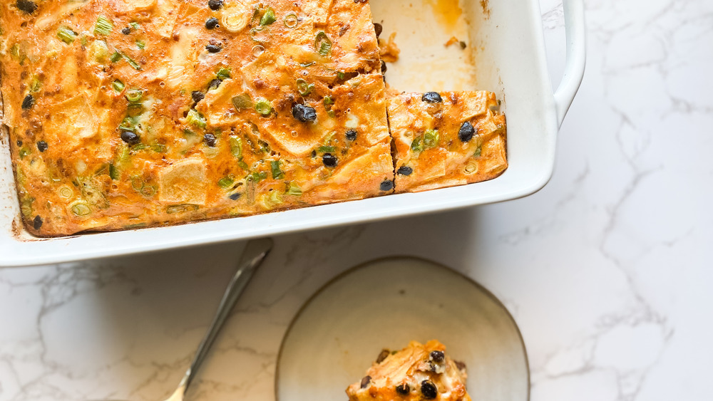 Baked Mexican breakfast casserole in white ceramic dish and on plate