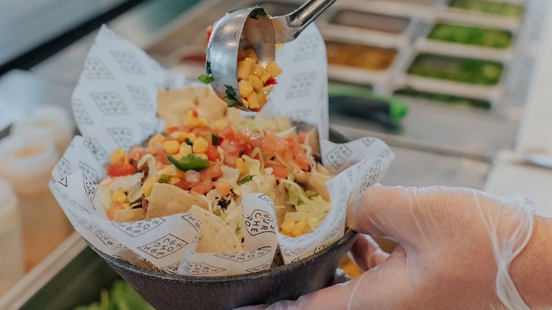 hand holding taco bowl